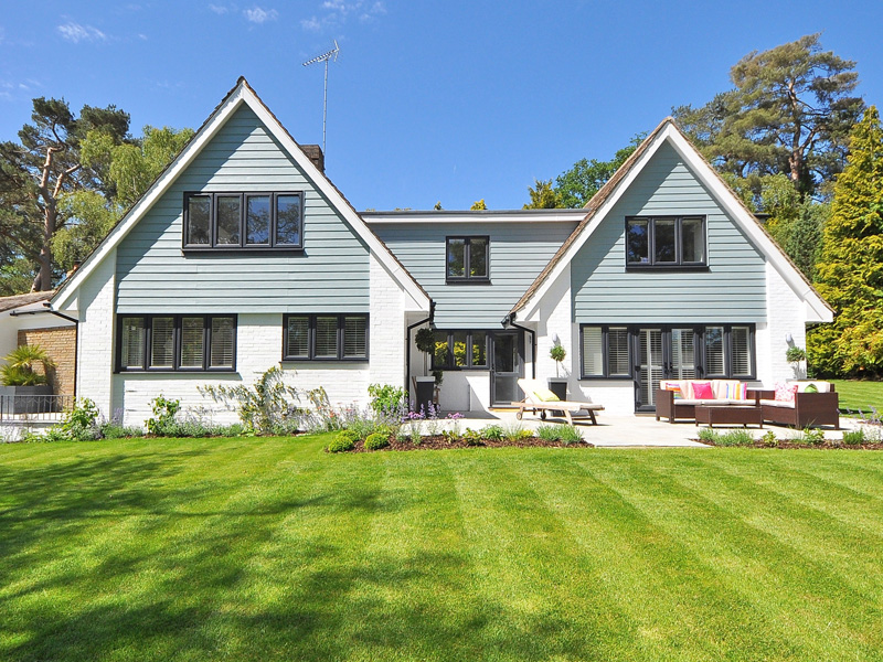 A large house with a lawn in front of it